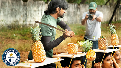 Most pineapples on heads cut in half in 30 seconds