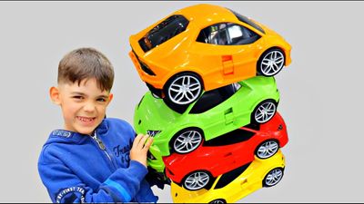 Alex Having Fun Playing with Lots of Cars